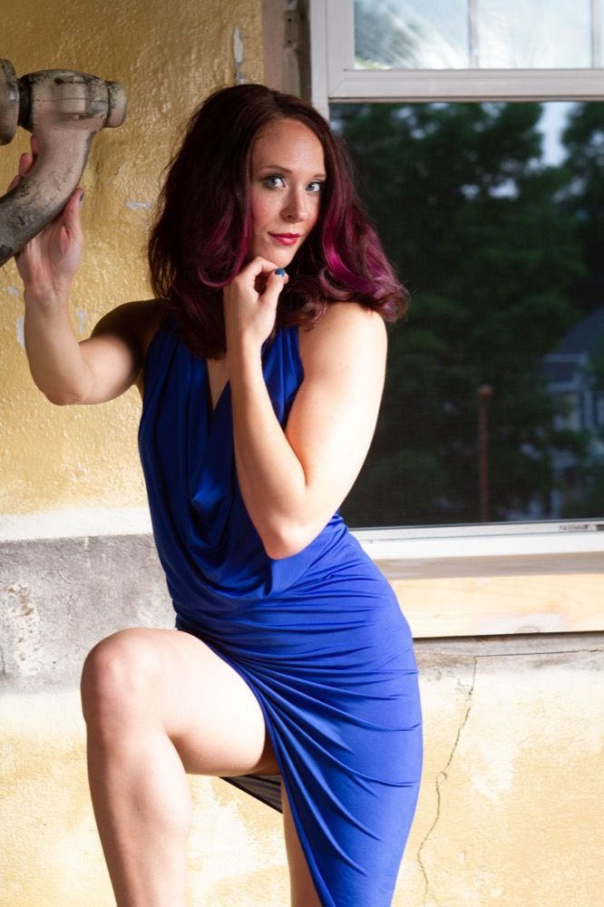 Portrait photograph of woman in blue dress