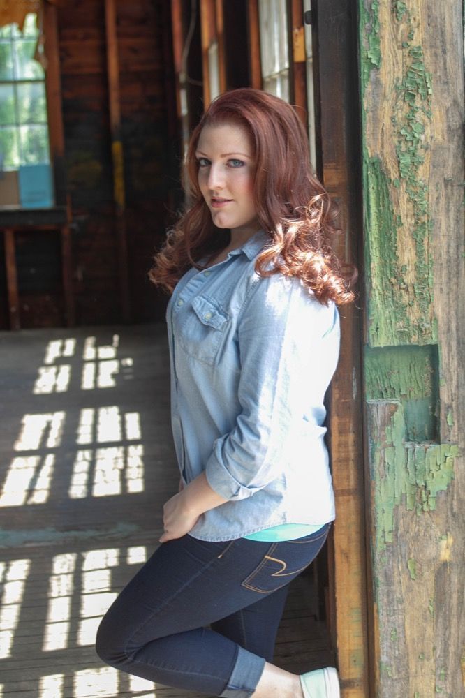 Portrait photograph of woman leaning against wall