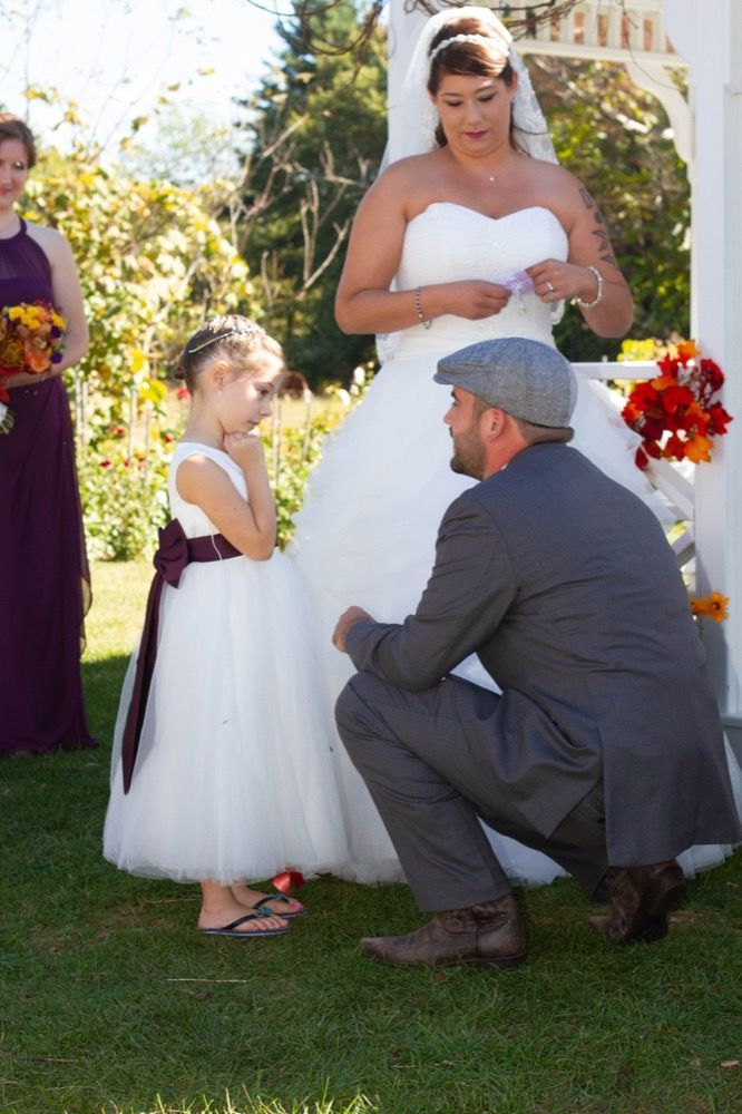Photo of bride and groom with flower girl