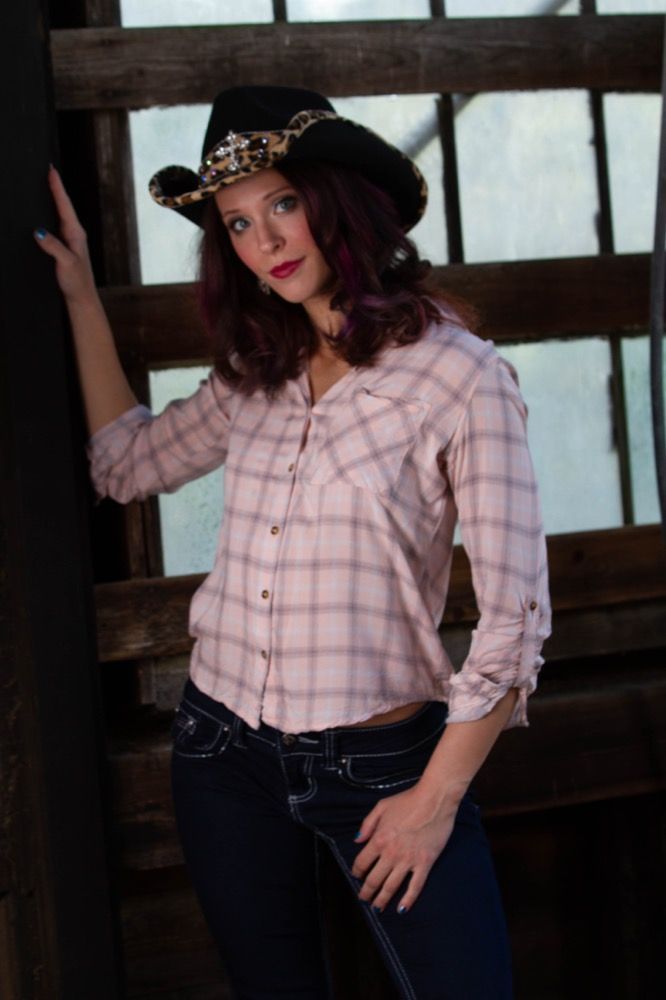 Portrait photograph of woman in cowboy hat