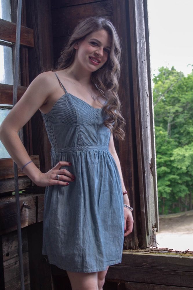 Portrait photograph of woman in blue dress